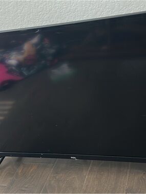 TLC and Roku Black Flat Screen TV with Slim Bezel
